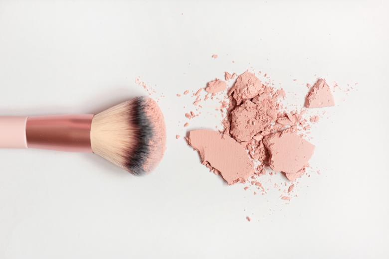 Pink blush powder and a brush - advertise on Suburban Tourist.