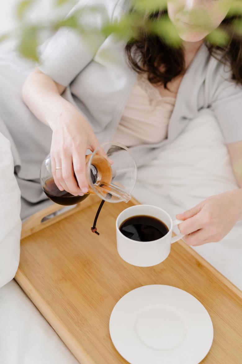 Faceless woman pouring coffee.