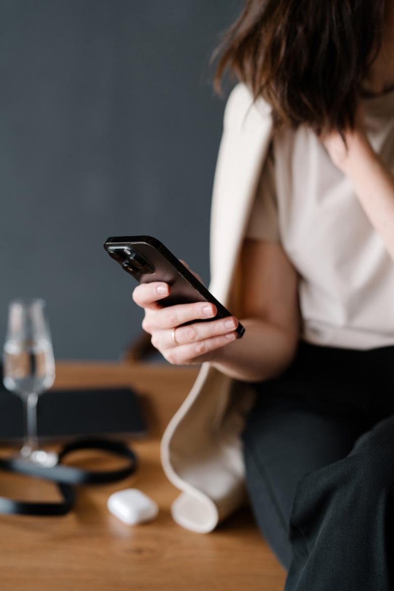 Faceless woman using a phone.