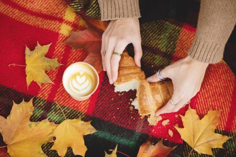Croissant and coffee outdoors - Fall bucket list ideas.
