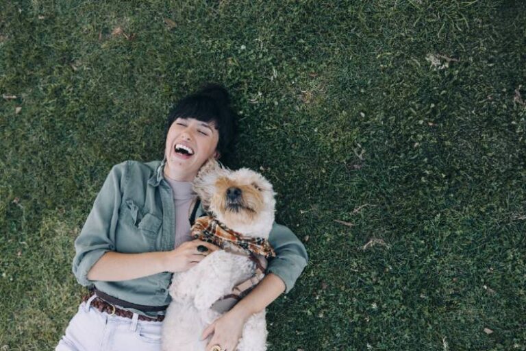 Woman playing with a puppy - funny life goals ideas from Suburban Tourist.