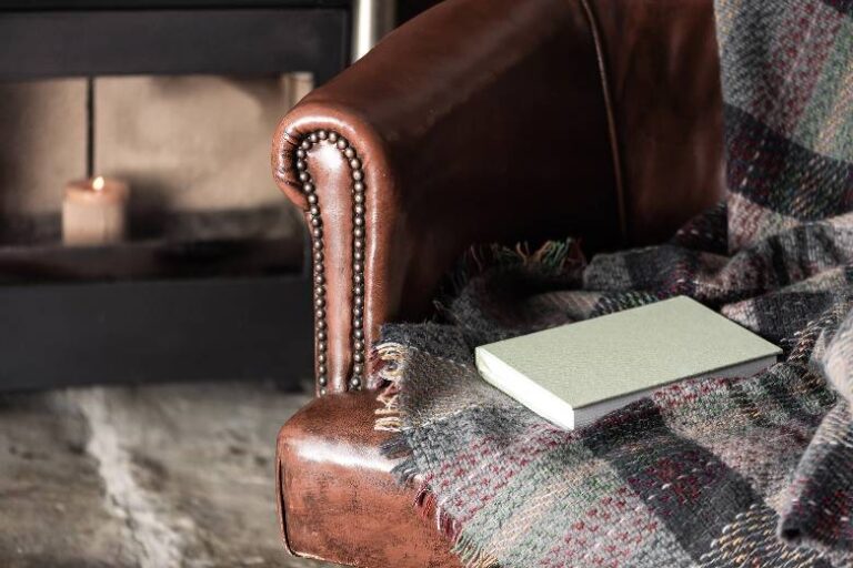 Leather chair with a book and blanket - how to enjoy winter.