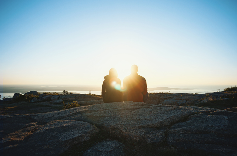 Two people sitting together - romantic hiking tips.