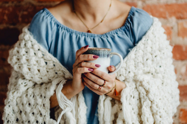 Woman drinking from a cup - self care tips for the Fall season