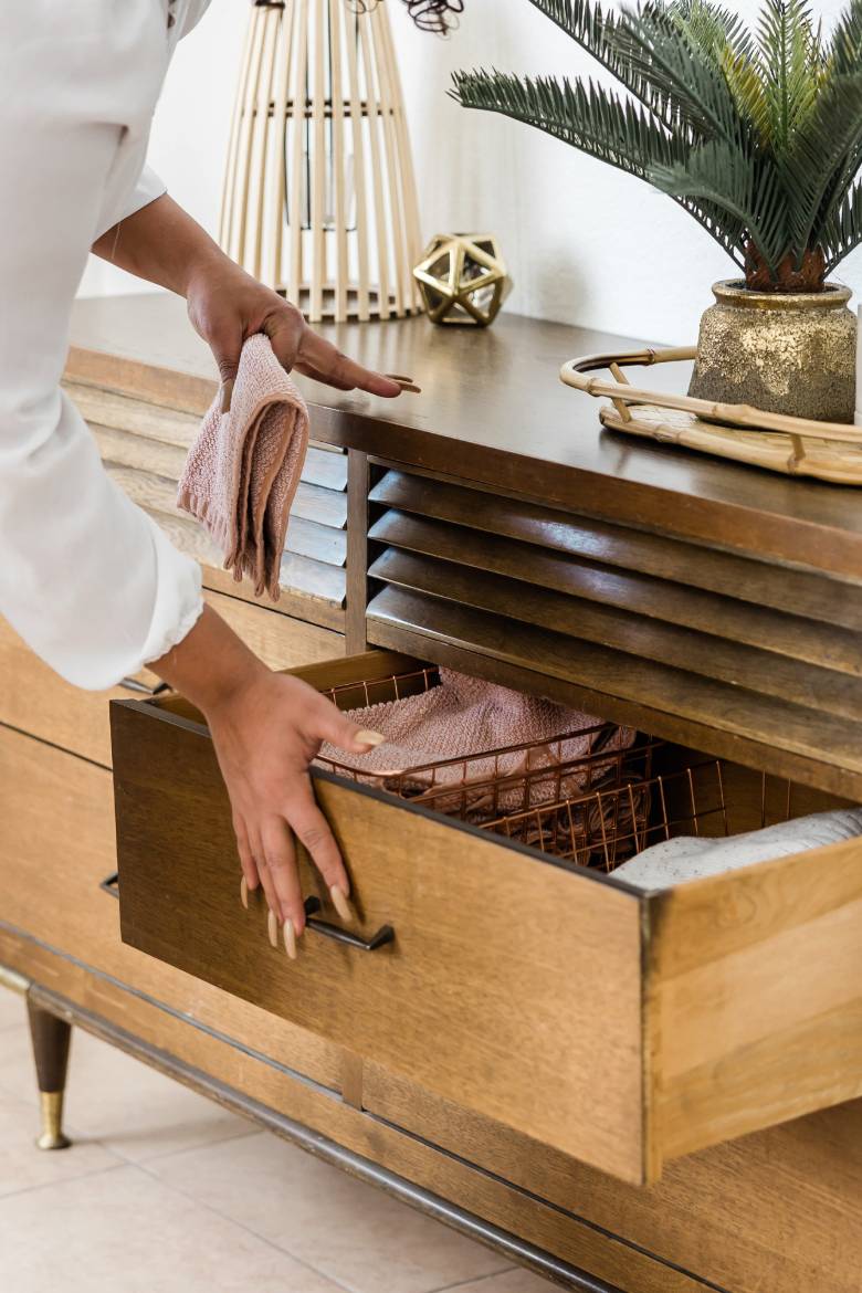 Faceless woman organizing her dresser drawer - Spring self-care ideas.