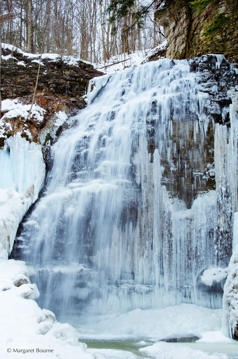 There are over 100+ waterfalls in the Hamilton region, and one of the prettiest is Tiffany Falls in Ancaster, Ontario. Learn why this is a favourite spot for a dose of nature in the summer, Fall and Winter periods. #waterfalls #waterfall #TiffanyFalls #Ancaster #Ontario #Daytripideas #Toronto
