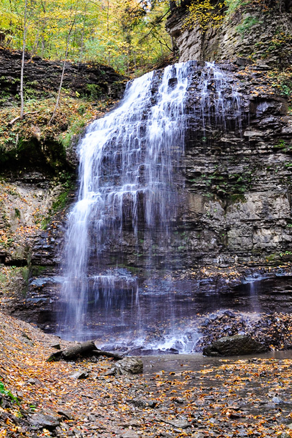 There are over 100+ waterfalls in the Hamilton region, and one of the prettiest is Tiffany Falls in Ancaster, Ontario. Learn why this is a favourite spot for a dose of nature in the summer, Fall and Winter periods. #waterfalls #waterfall #TiffanyFalls #Ancaster #Ontario #Daytripideas #Toronto