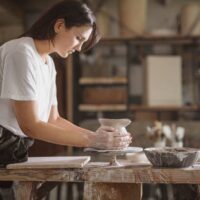 Tips for starting a new hobby that you can transform into a business - woman creating pottery.