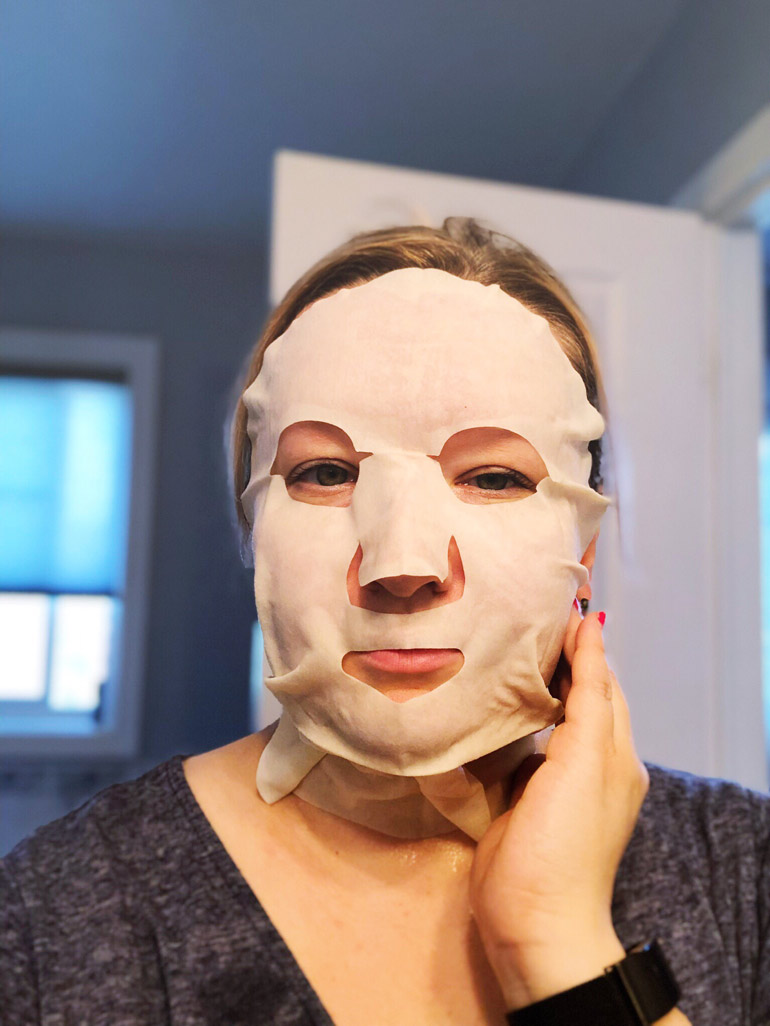 A woman with a Teaology face mask on her face.